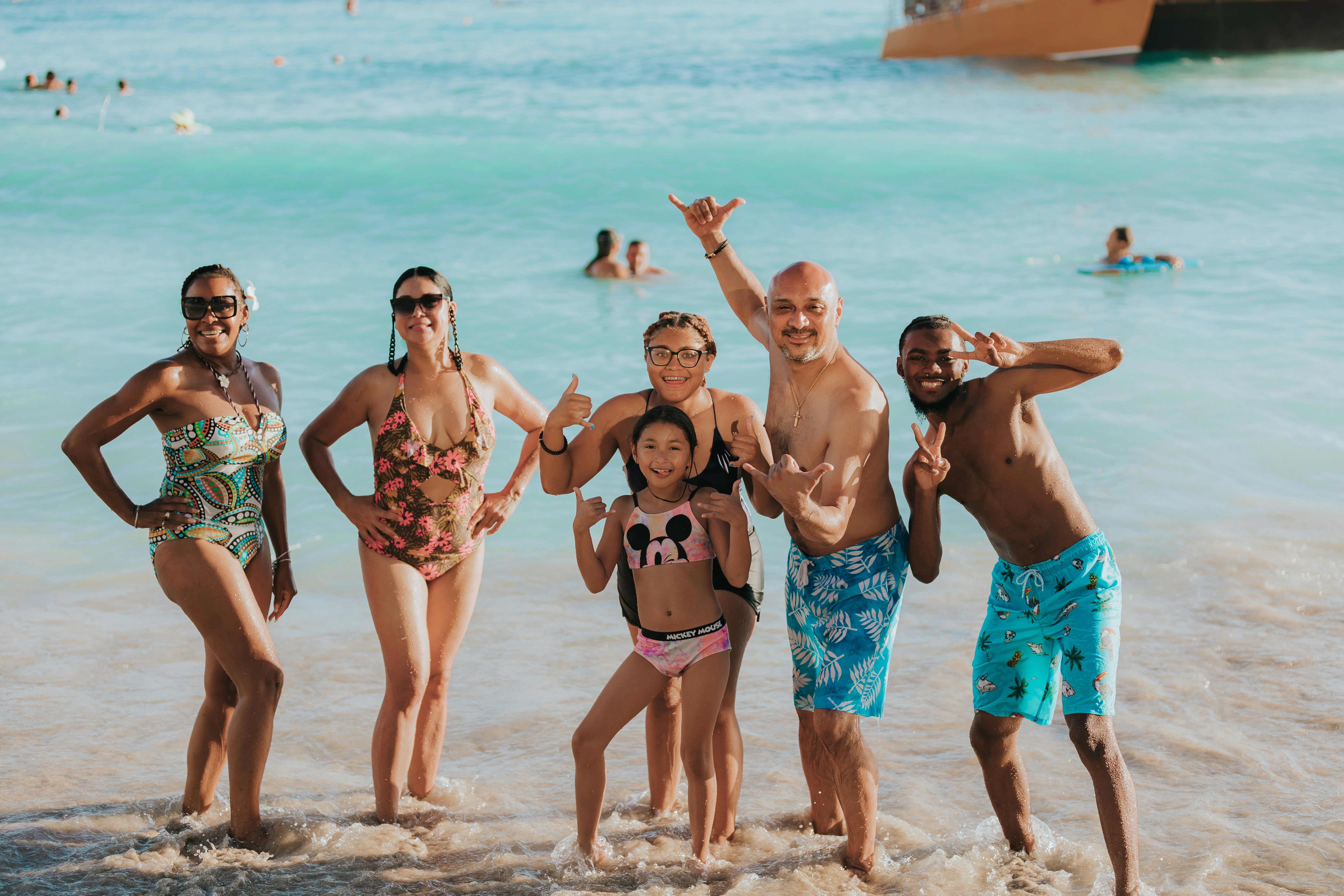 a group of people posing for a photo on a beach