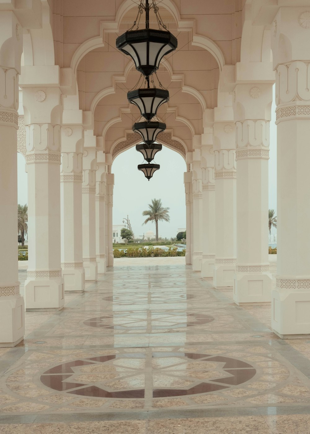 a large white hallway with a lamp