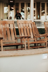 A stylish patio rocking chair set made from natural wood, inviting you to relax outdoors.