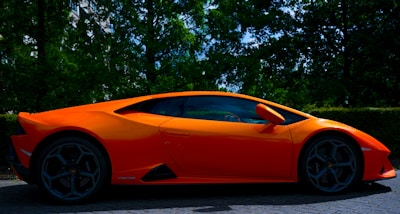 A sleek car parked on a quiet Orange County street under a clear blue sky.