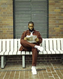 a man wearing co-ord set sitting on a bench