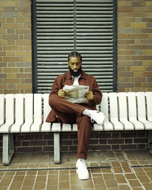 a man wearing co-ord set sitting on a bench