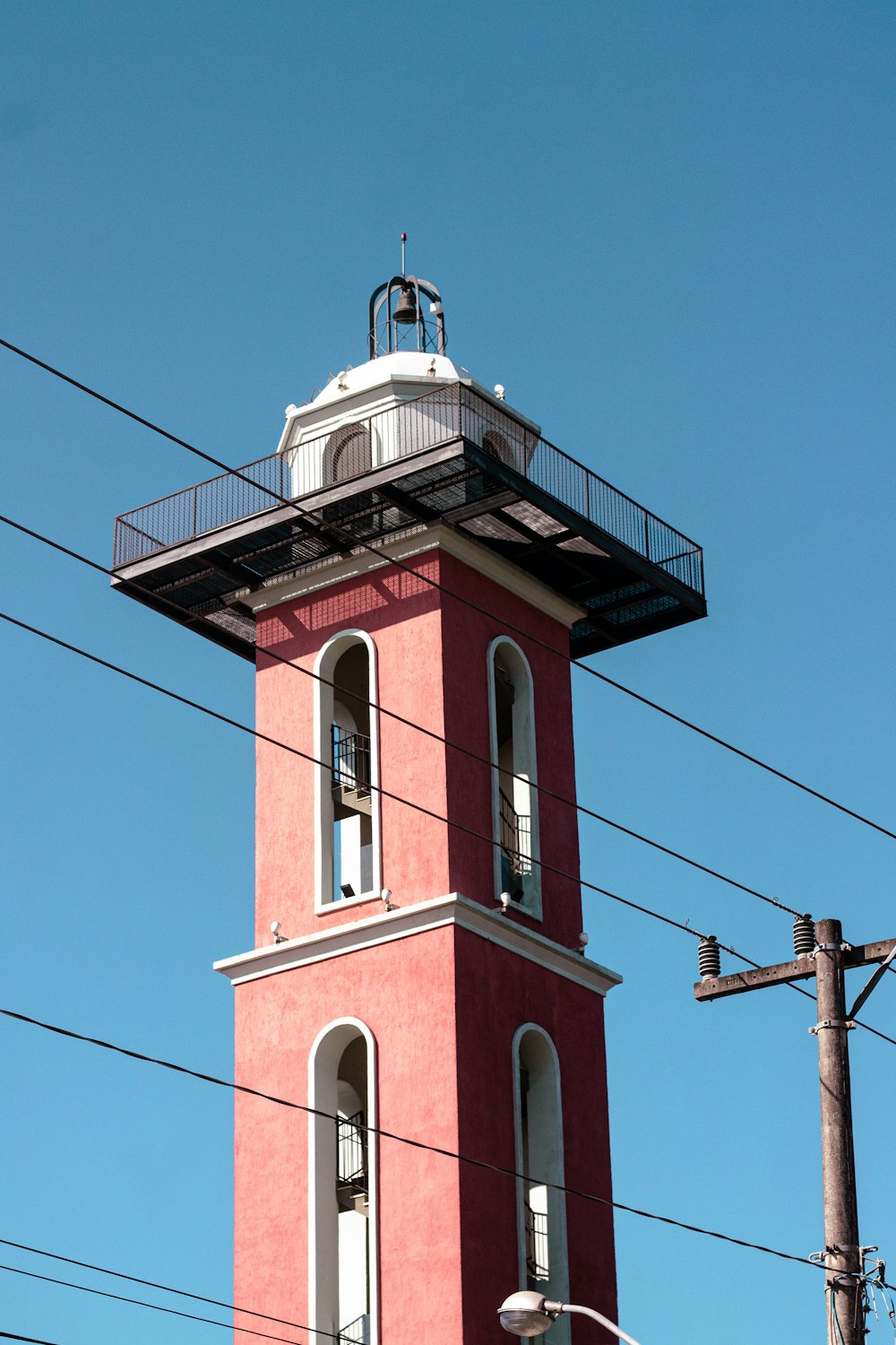 a red tower with a white top