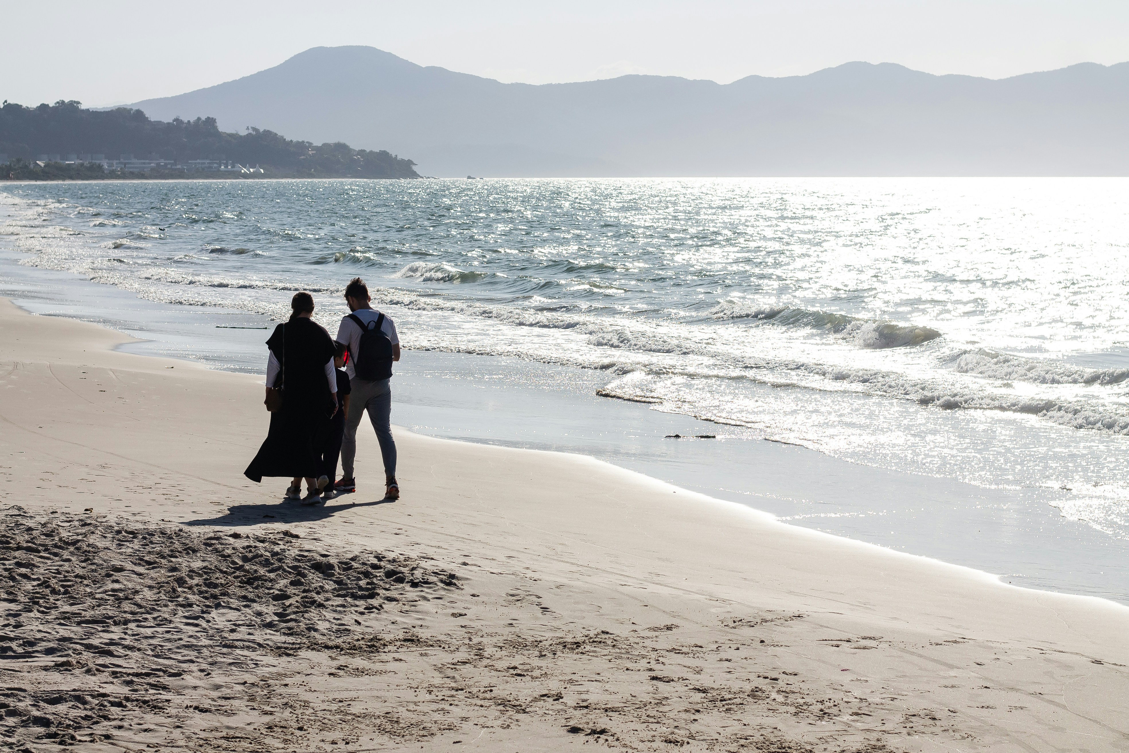 a couple walking on a beach
