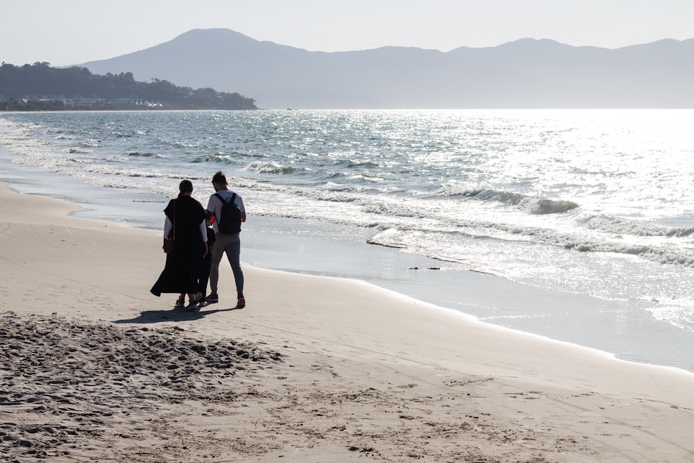 a couple walking on a beach