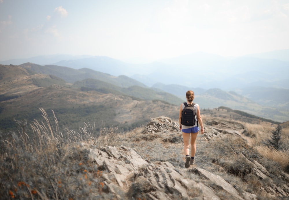 a man walking on a rocky hill