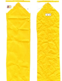 Two elongated, crumpled yellow plastic bags are displayed side by side. The left bag features a faint print of colors near the top, while the right one has a small label with text and recycling symbols.