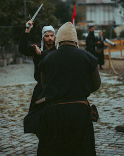 Participants dressed in medieval costumes competing in a lively outdoor tournament.