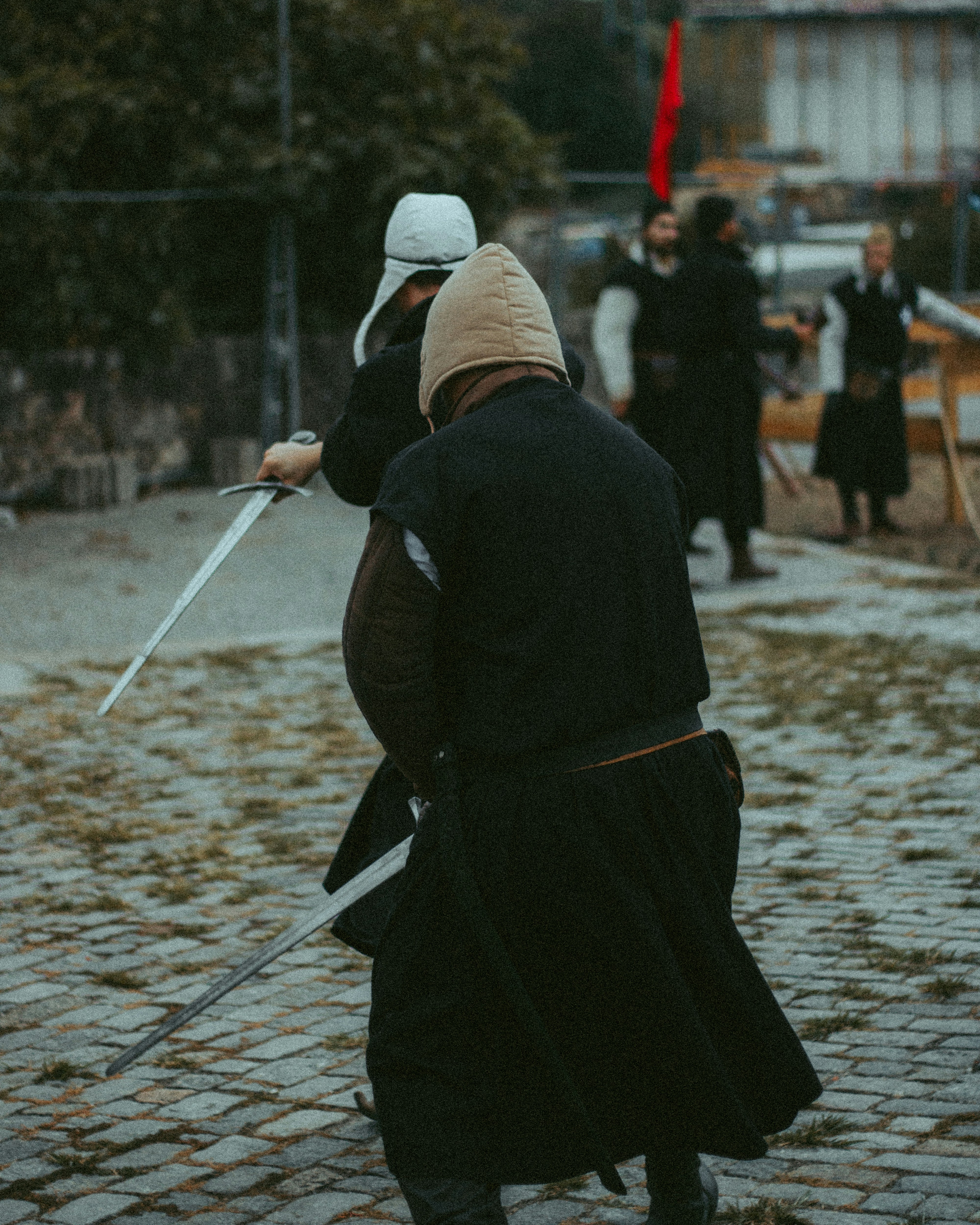 a person in a garment holding a sword