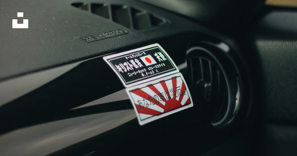 A sticker on a car dashboard photo – Free Automobile Image on Unsplash