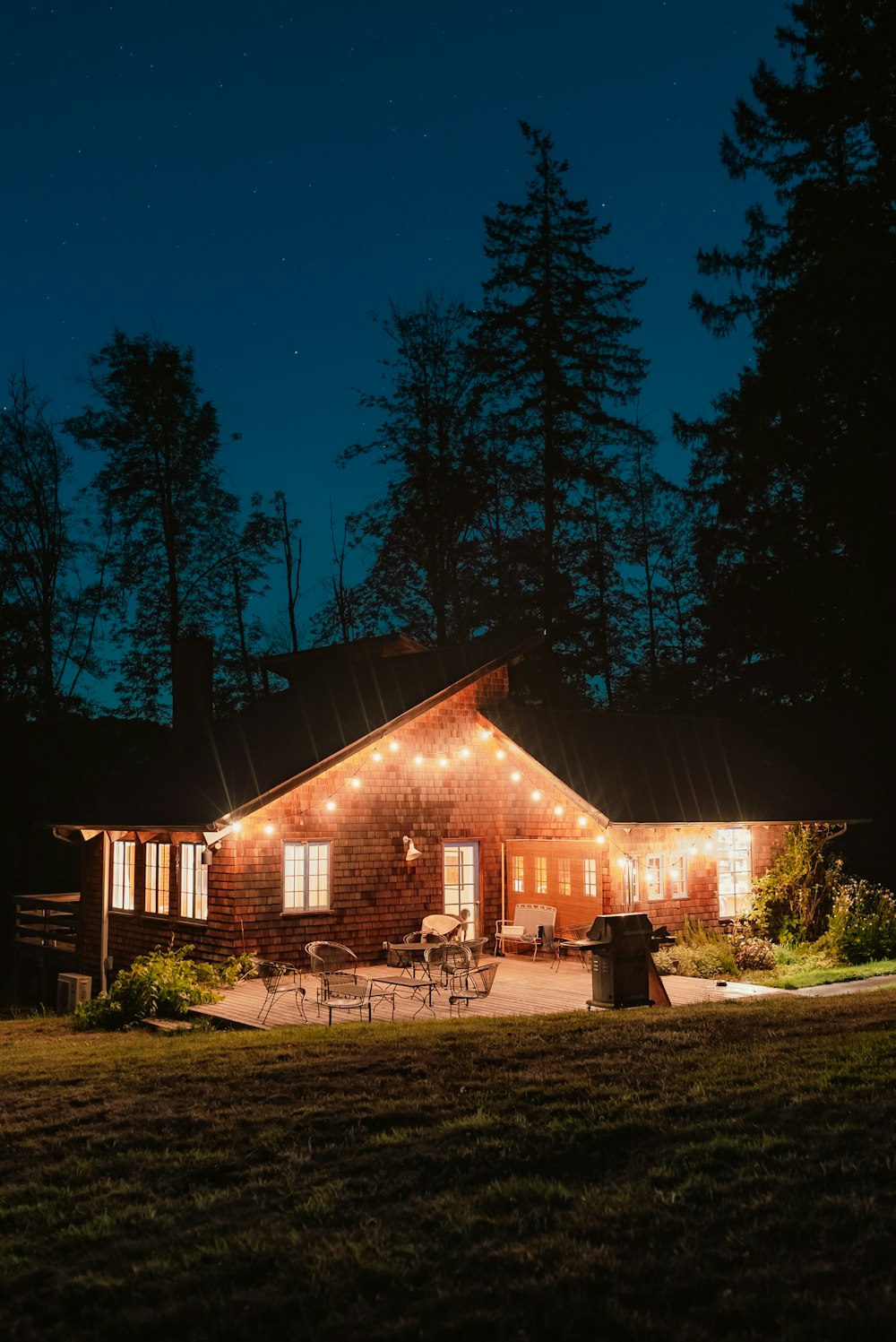 a house with a large yard at night