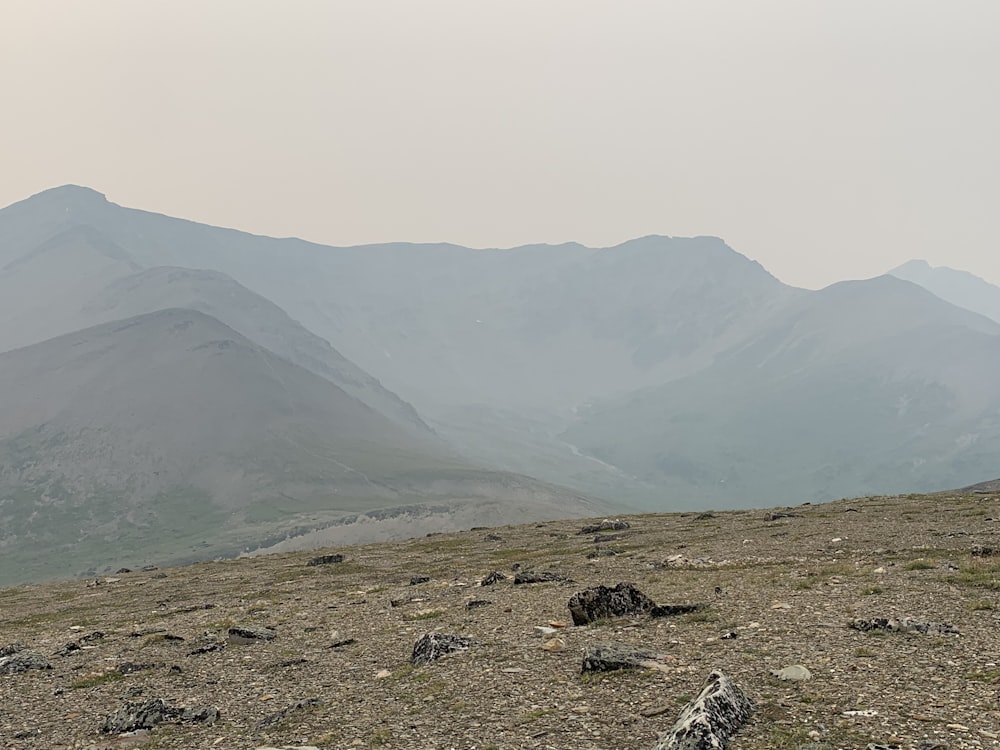 a rocky area with hills in the background