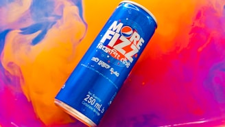 Different sizes of Carnavalera foam cans (250 ml, 500 ml, 750 ml) displayed on a festive table.