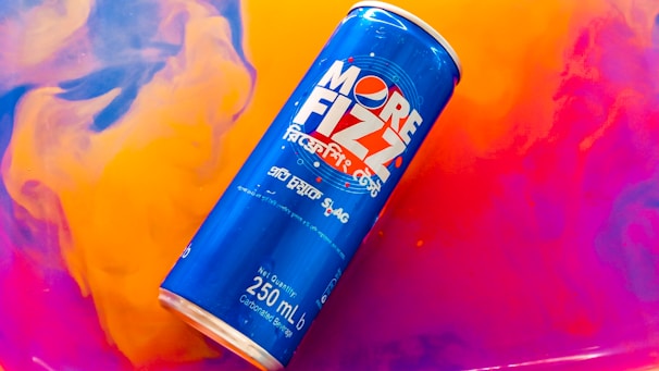 Different sizes of Carnavalera foam cans (250 ml, 500 ml, 750 ml) displayed on a festive table.