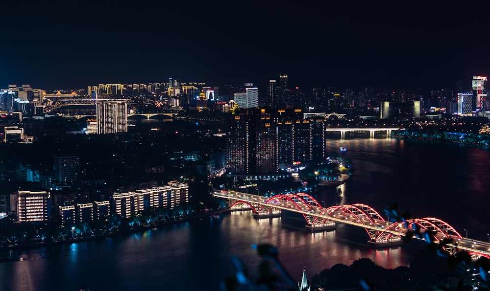 a bridge over a river in a city at night