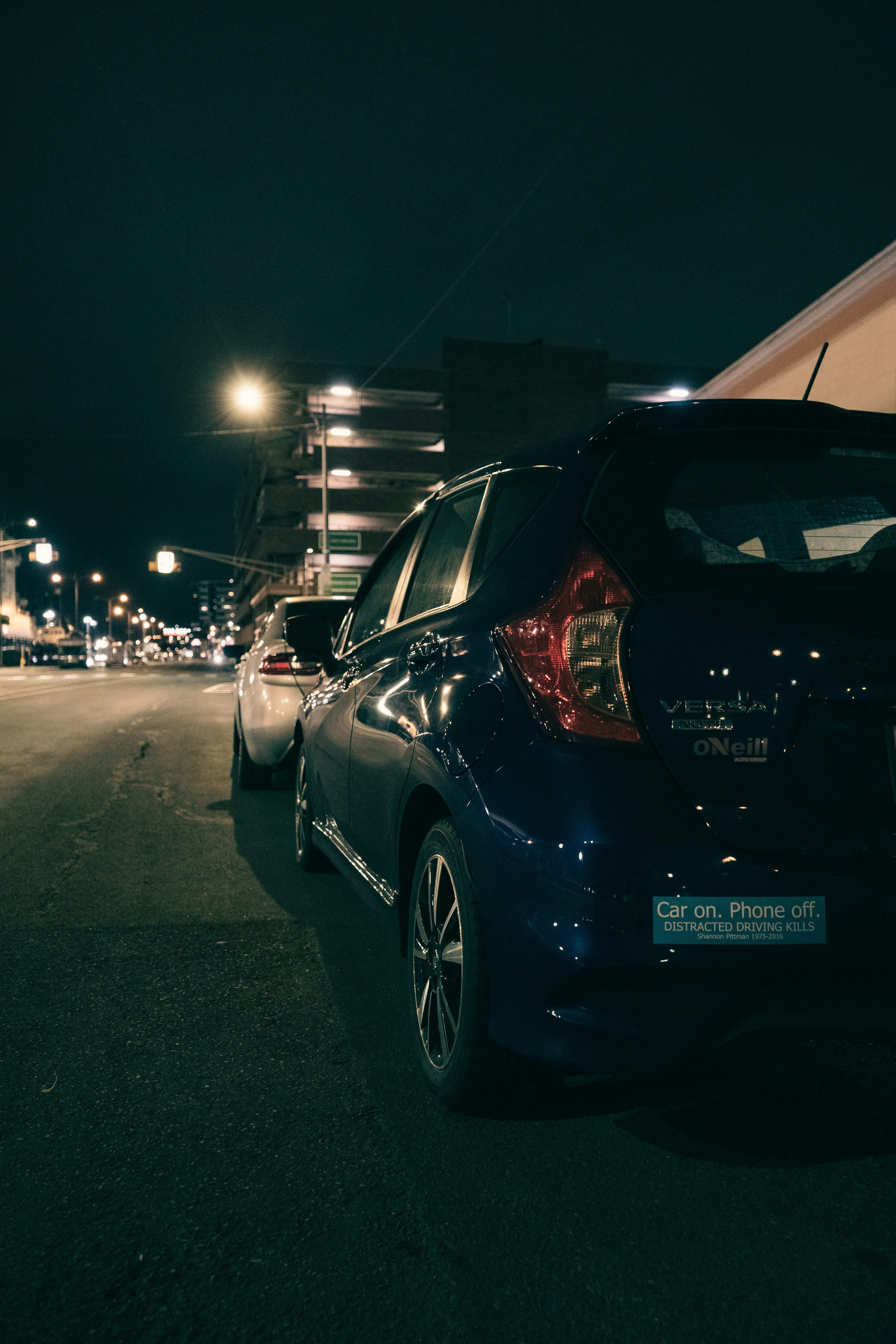 A car parked on the side of a road at night photo – Free Car Image on ...