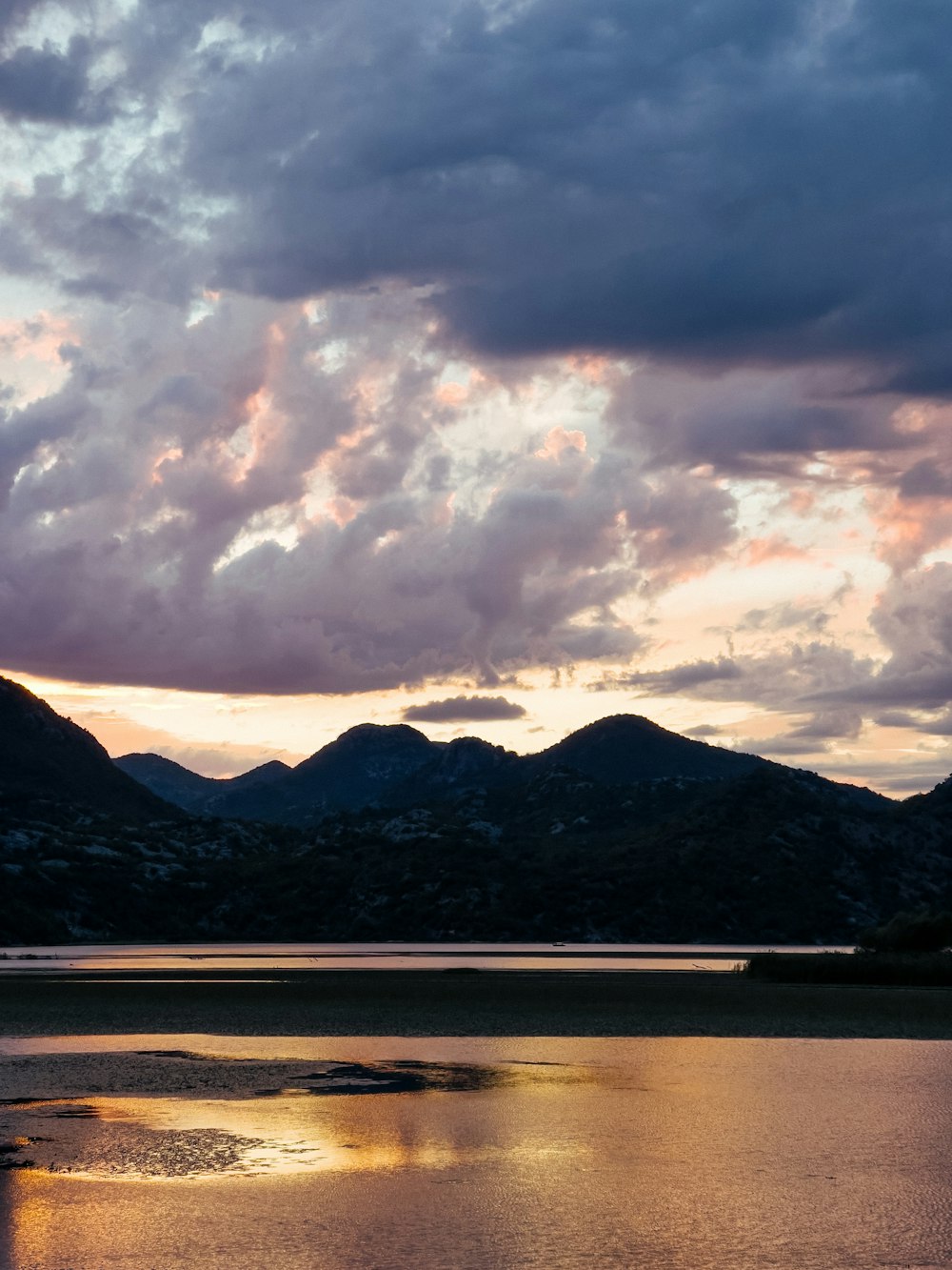 a body of water with a mountain in the background