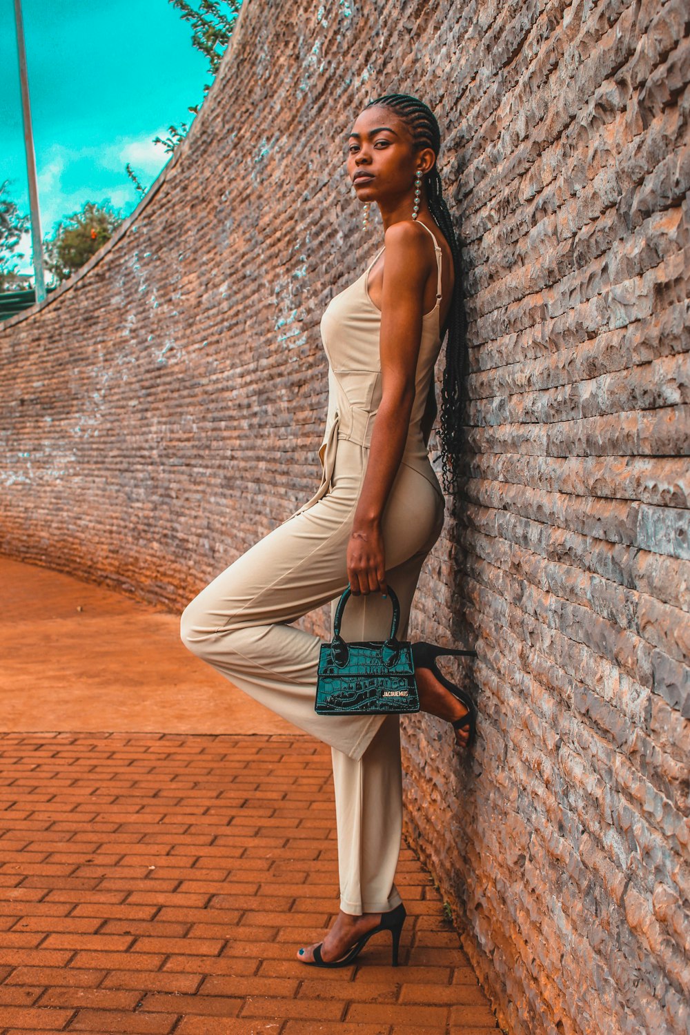 a person leaning against a brick wall