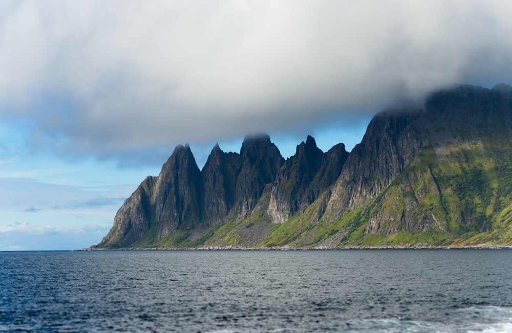 a body of water with a mountain in the background