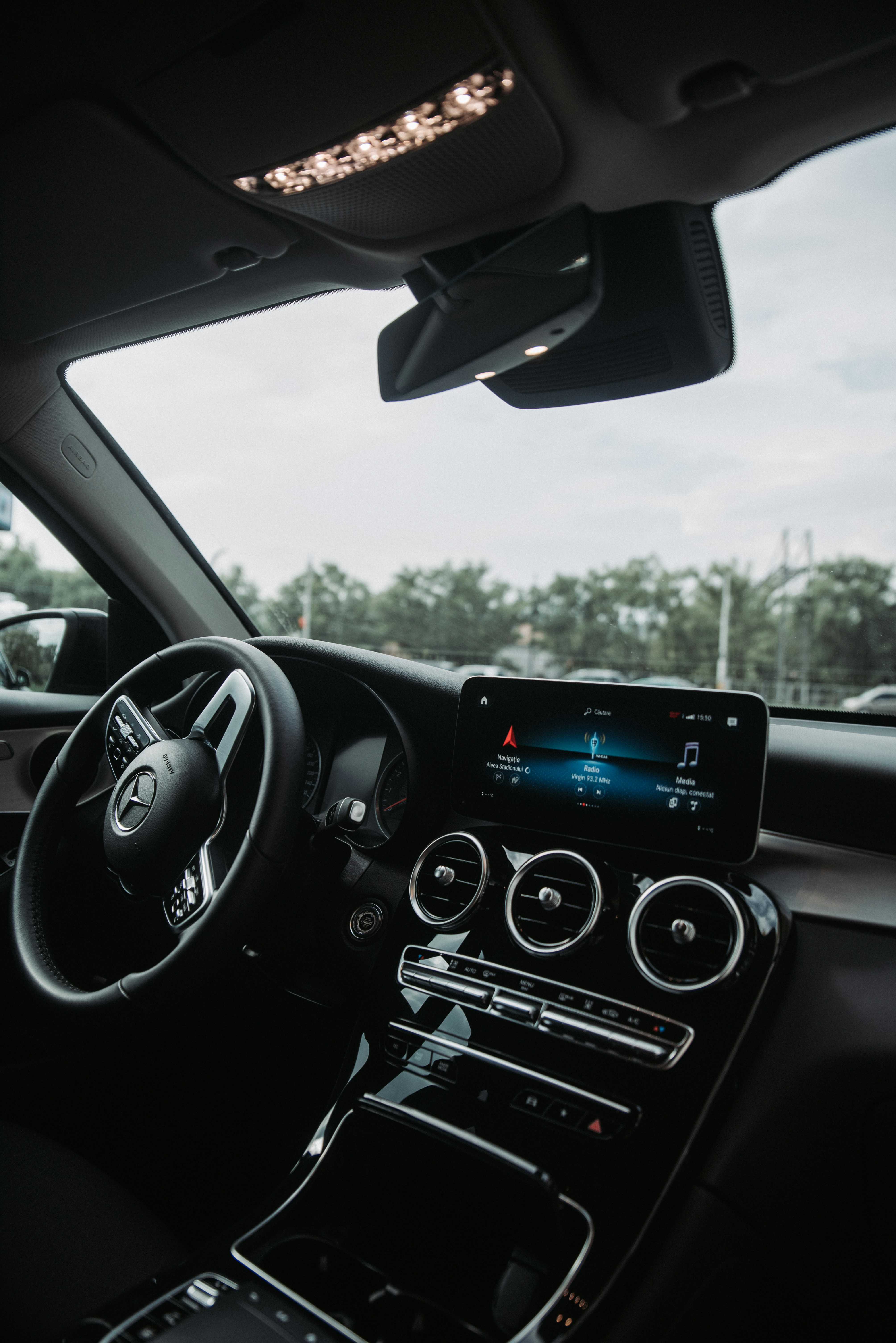 Modern automotive dashboard with blue digital display, dark cockpit interior with illuminated controls