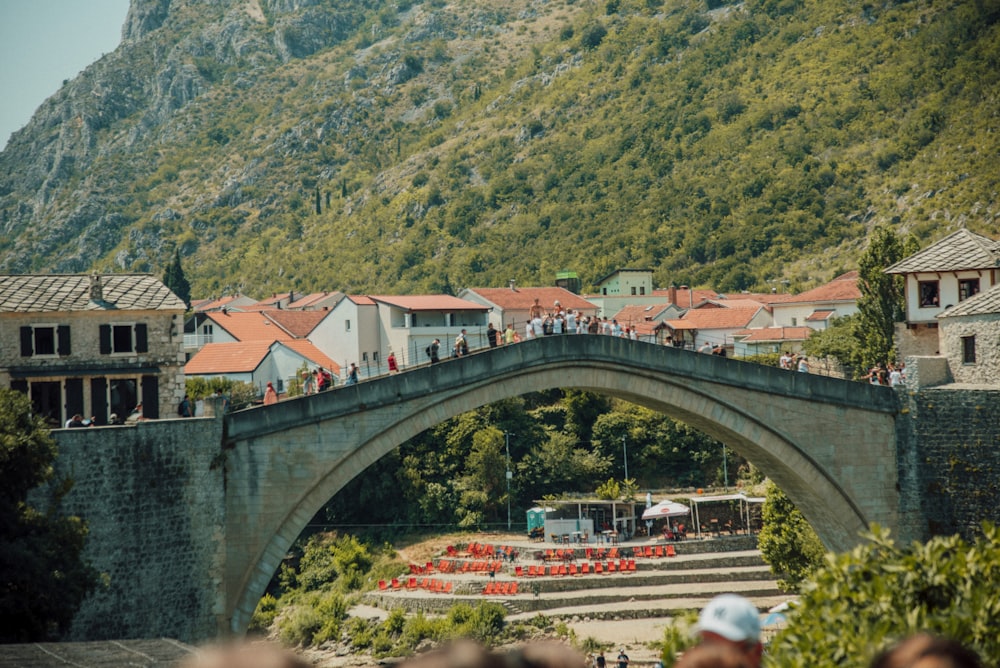 a bridge over a river with buildings and trees on the side