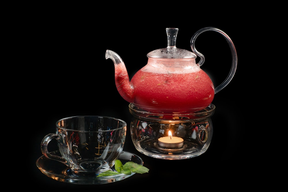 a tea kettle and a glass cup