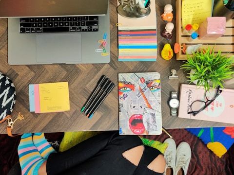 Flat lay of colorful web design tools and notes on a table.