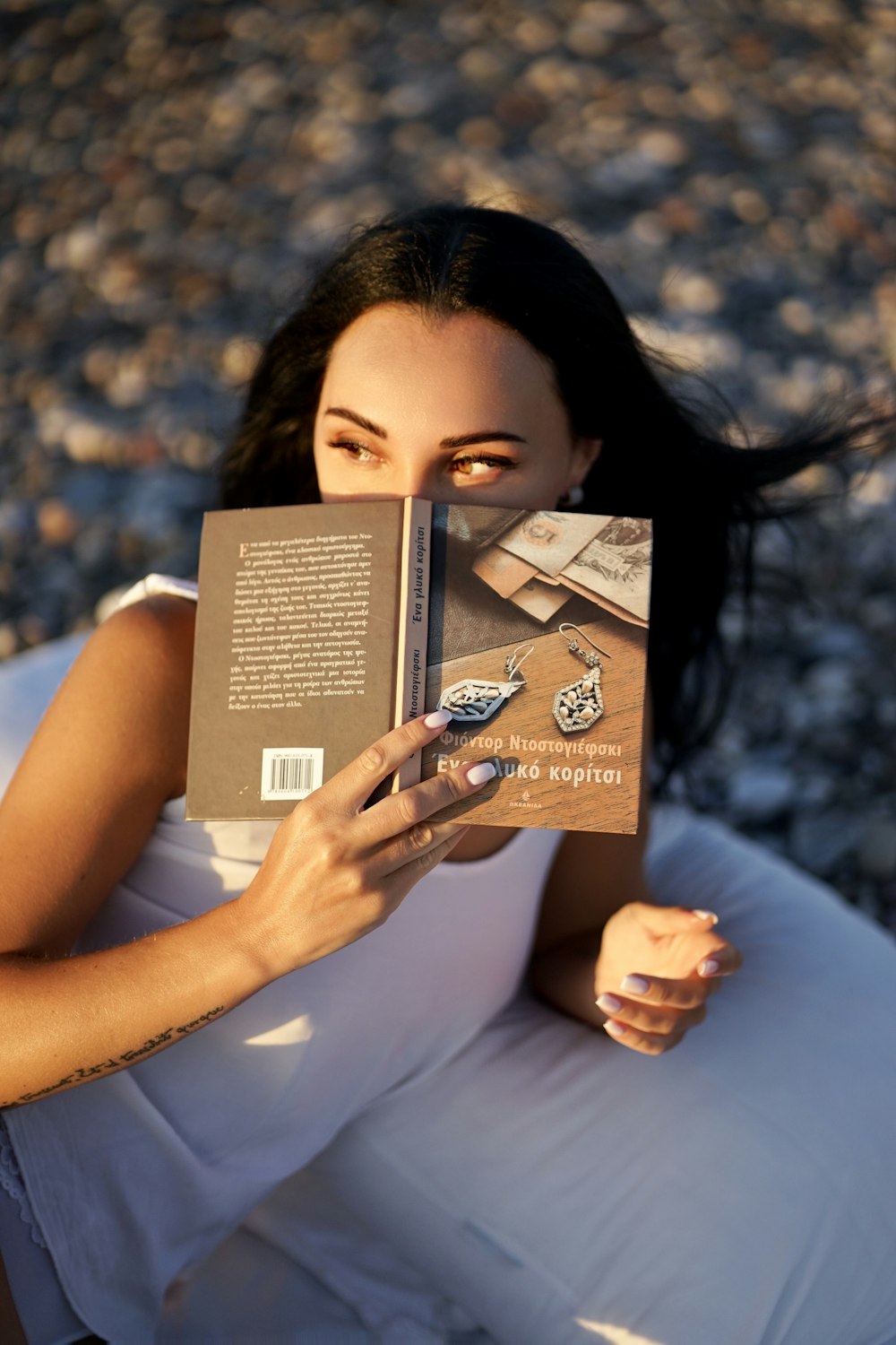 a woman lying on the ground reading a book