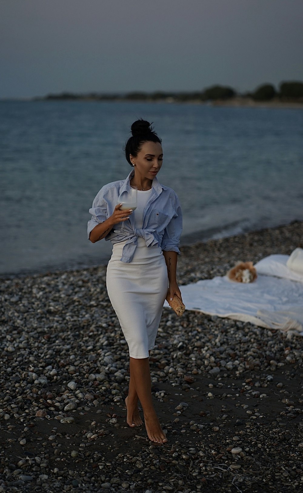 a person standing on a rocky beach