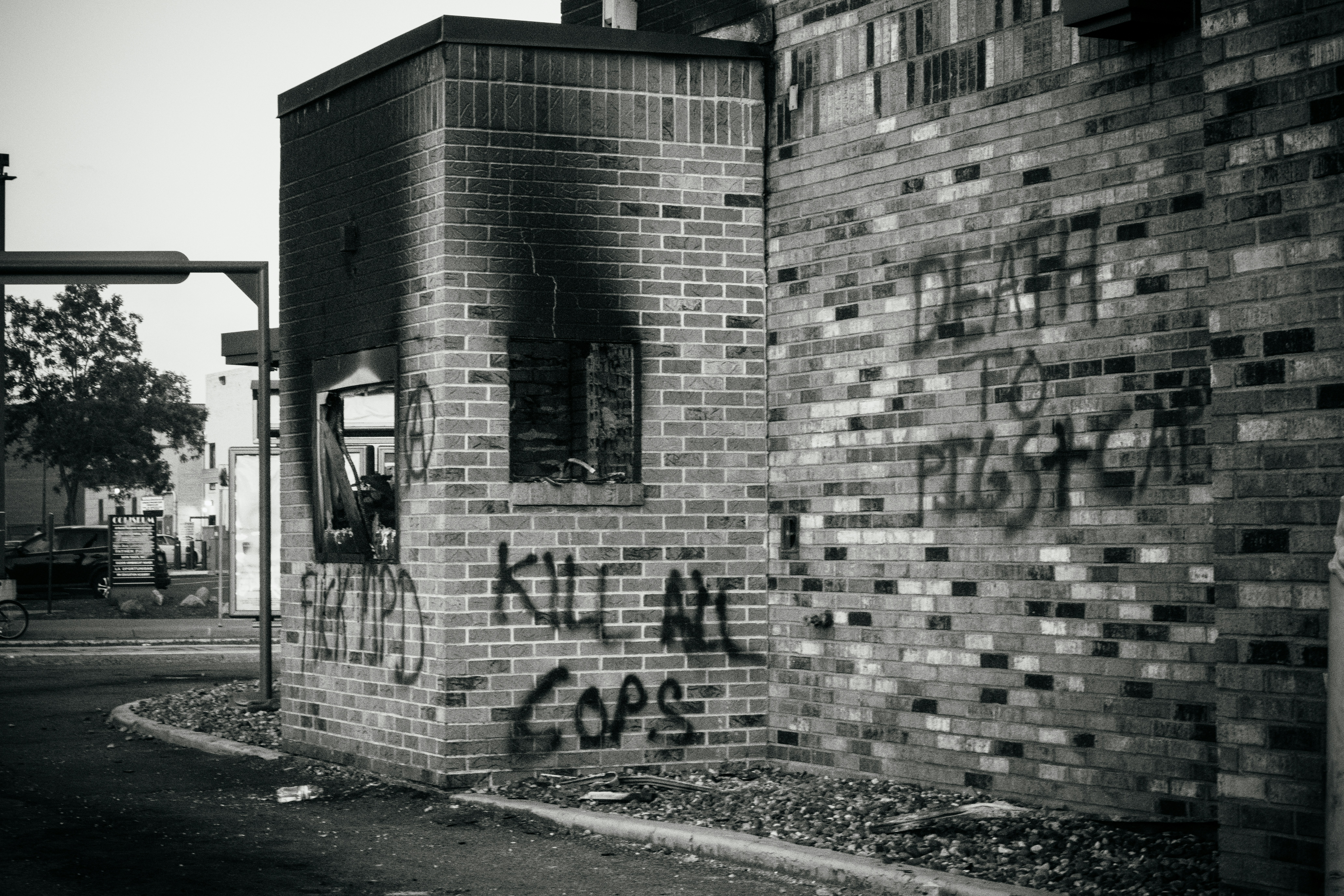 a brick building with graffiti on it