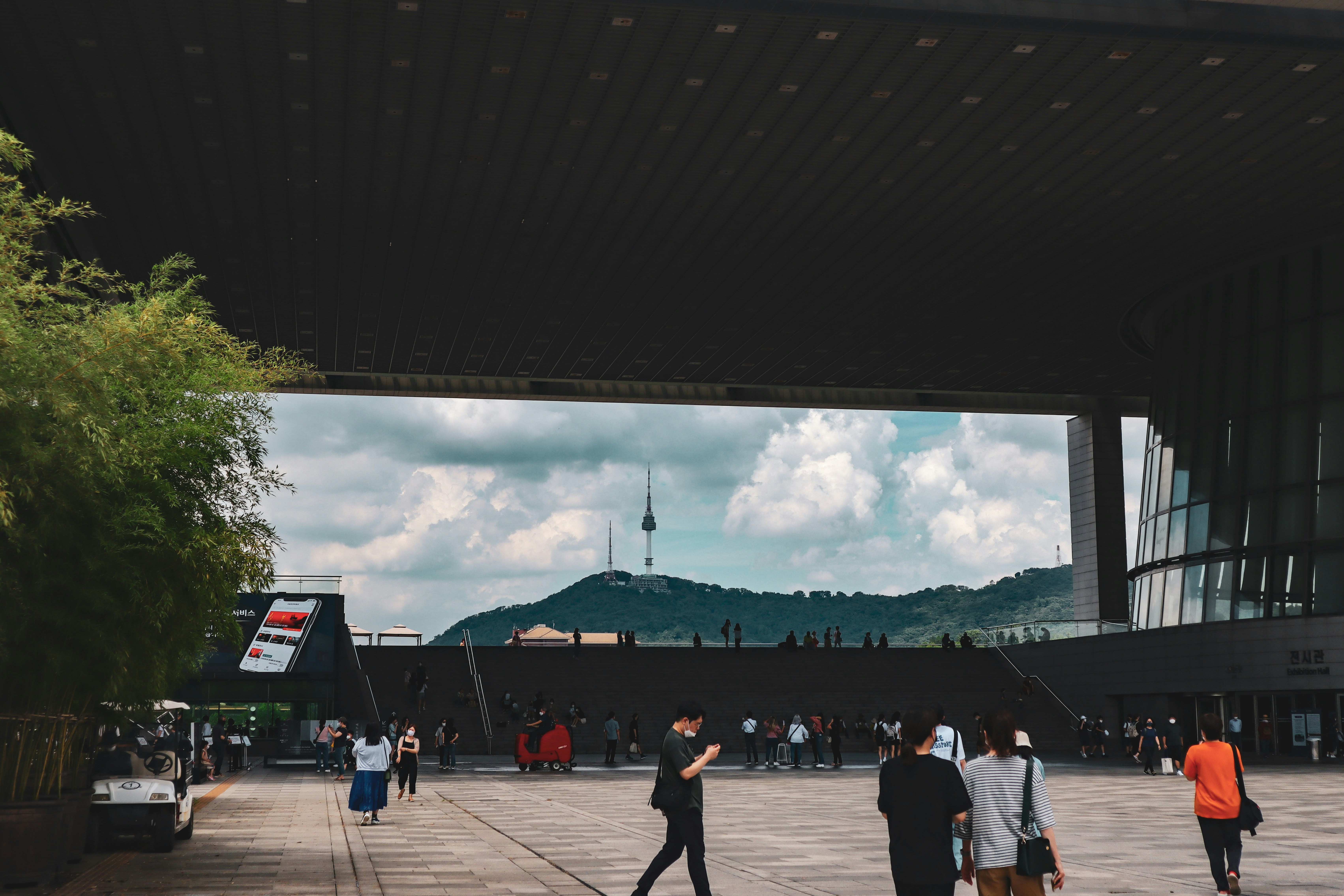a group of people walking under a bridge