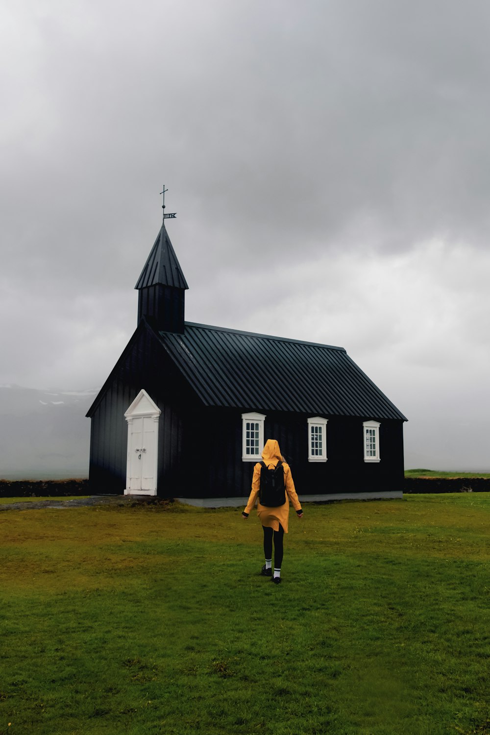 a man walking in front of a church