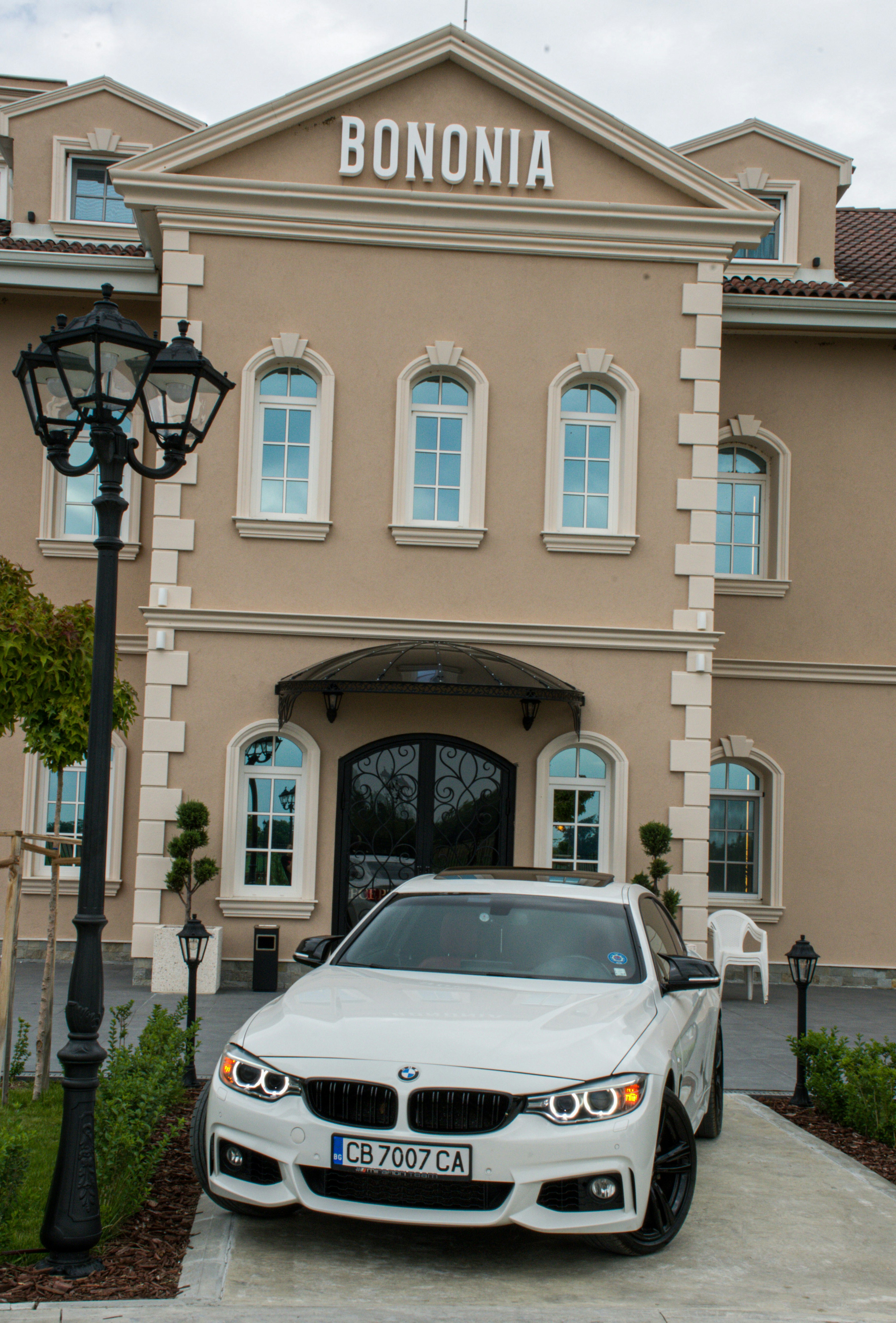 a white car parked in front of a building