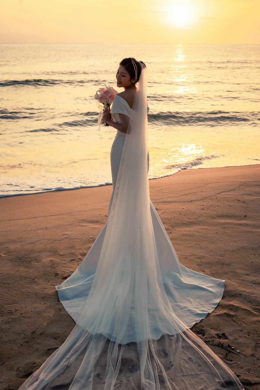 a person in a wedding dress on a beach