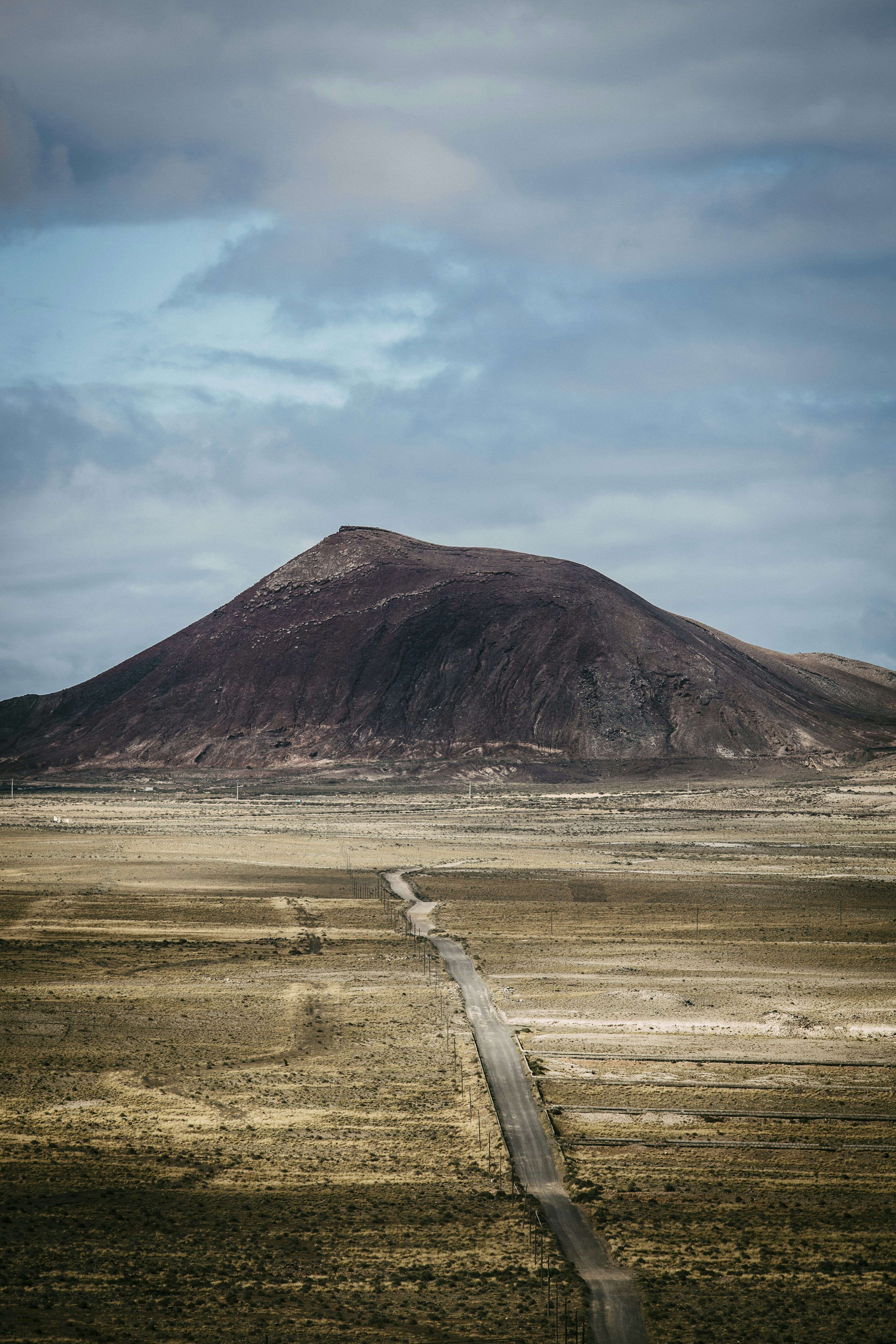 a dirt road leading to a mountain