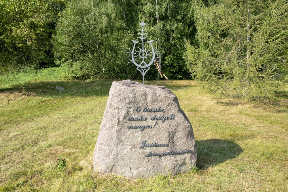 a stone with a cross on top