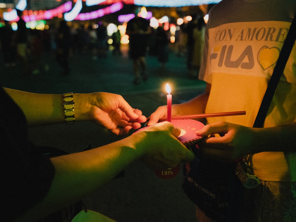 a group of people holding a candle