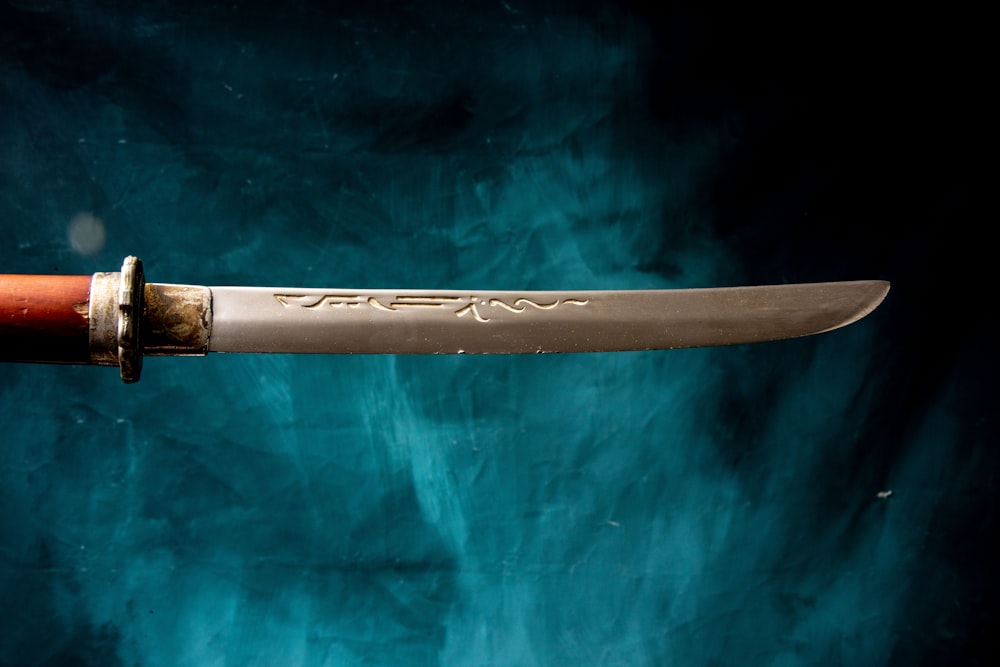 a sword on a blue surface