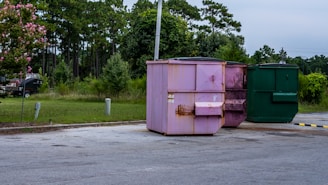 a group of green dumpsters