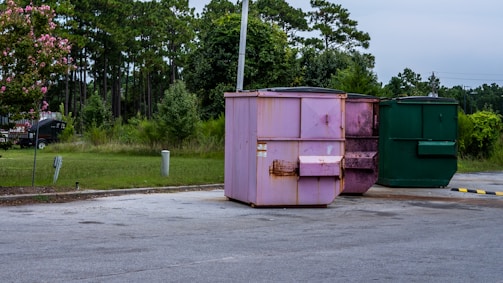 a group of green dumpsters