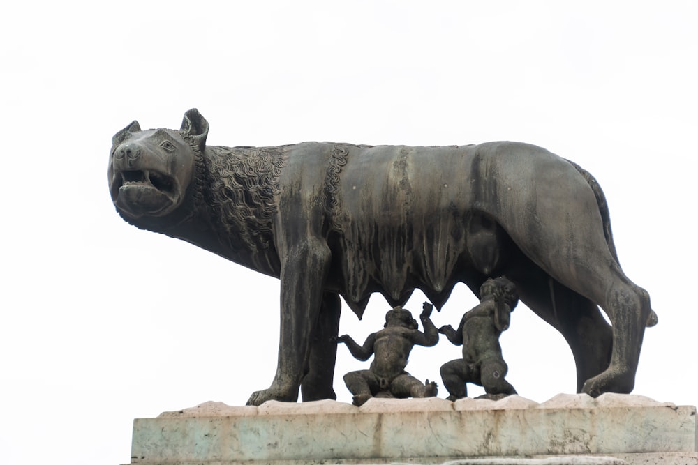 a statue of a bear and several baby bears