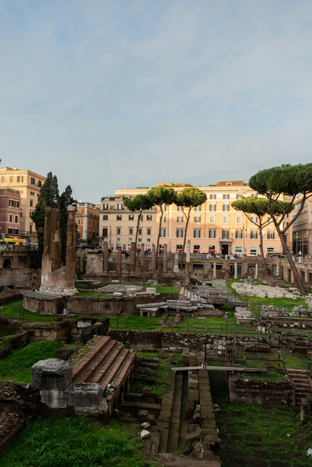 a group of buildings with trees and grass in front of them