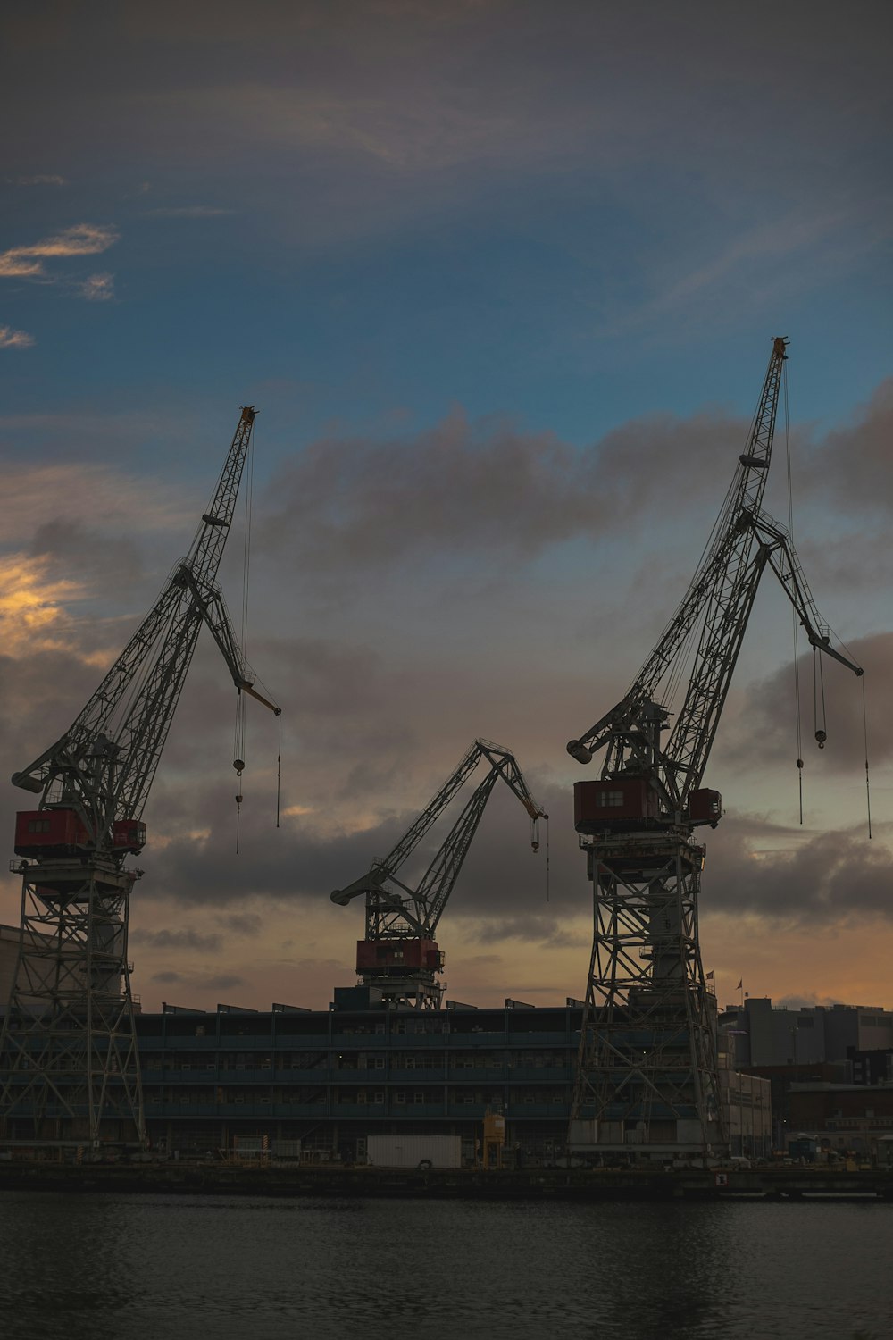 a group of cranes next to a building