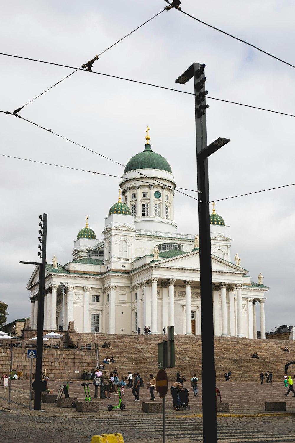 a large white building with a domed roof and a cross on top