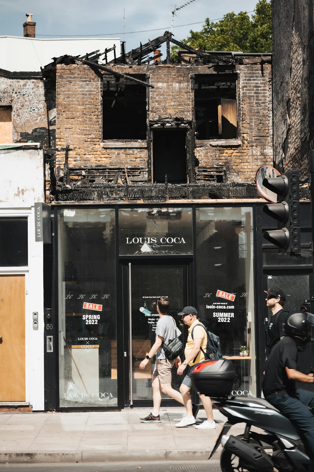 a group of people walking out of a building