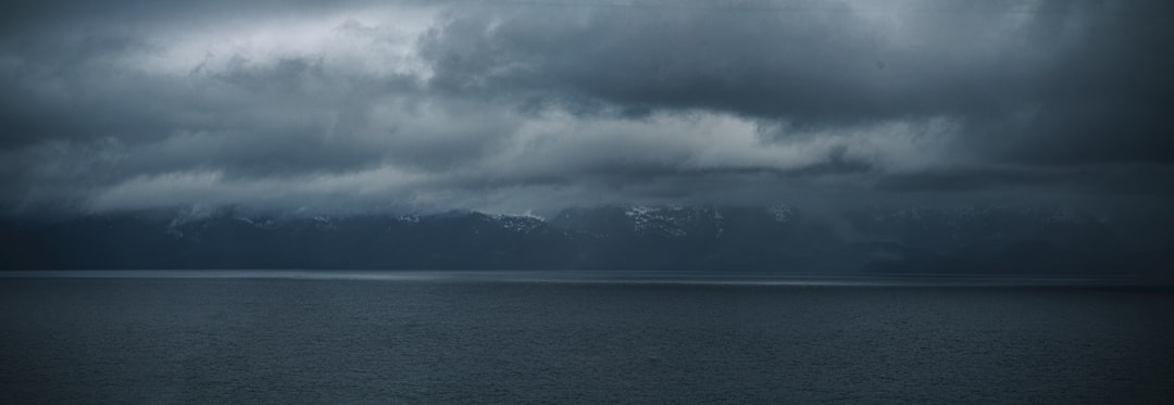 a body of water with mountains in the background,