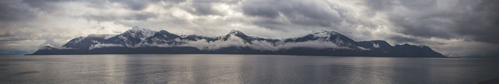 a body of water with mountains in the background