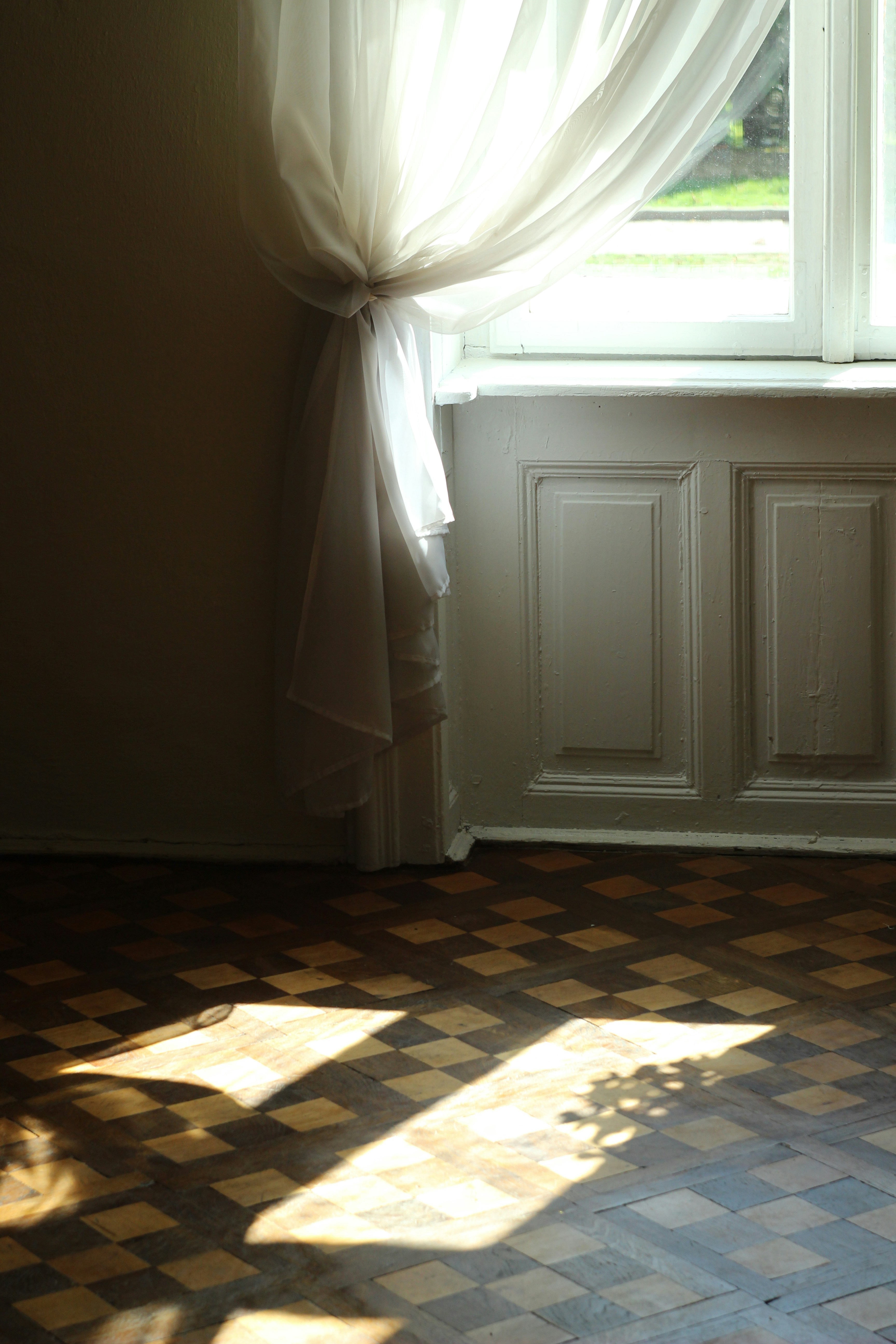 a room with a window and curtains