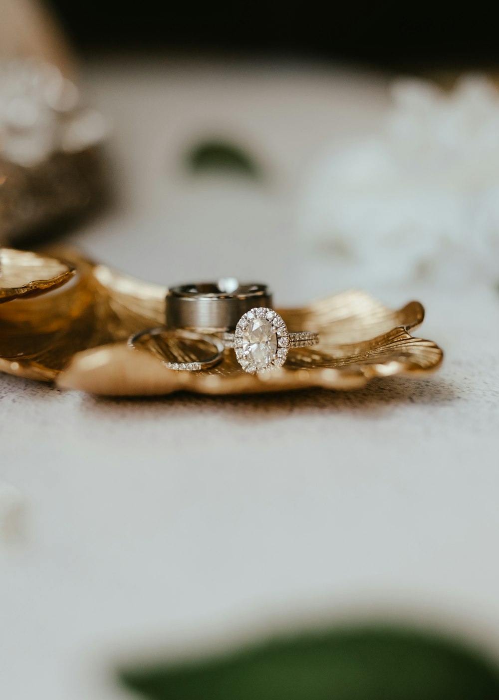 a gold ring on a white surface