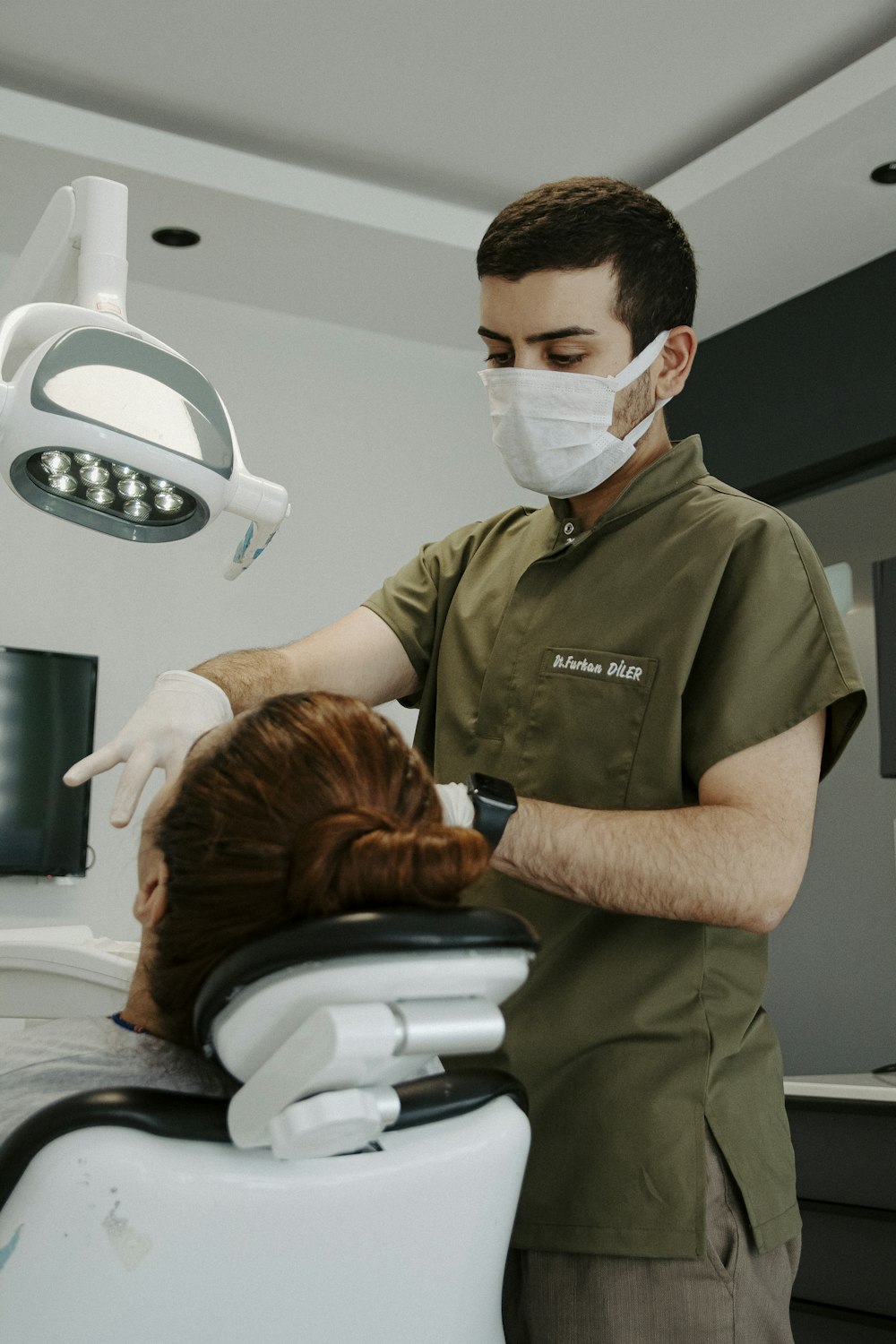 a man in a mask and a woman in a hospital bed